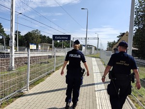 Policjantka wraz z funkcjonariuszem Straży Ochrony Kolei patroluje dworzec kolejowy.