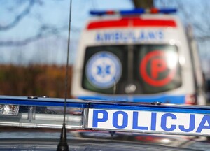 Zdjęcie poglądowe. Policyjne sygnały a w tle karetka pogotowia.
