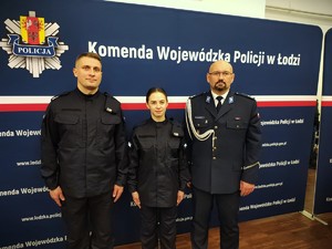 Policjant i policjantka pozują do zdjęcia z Zastępcą Komendanta Powiatowego Policji w Łasku.